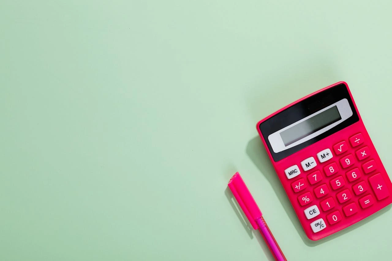 A close-up of an image with a calculator conveying focus and preparation with brand colors