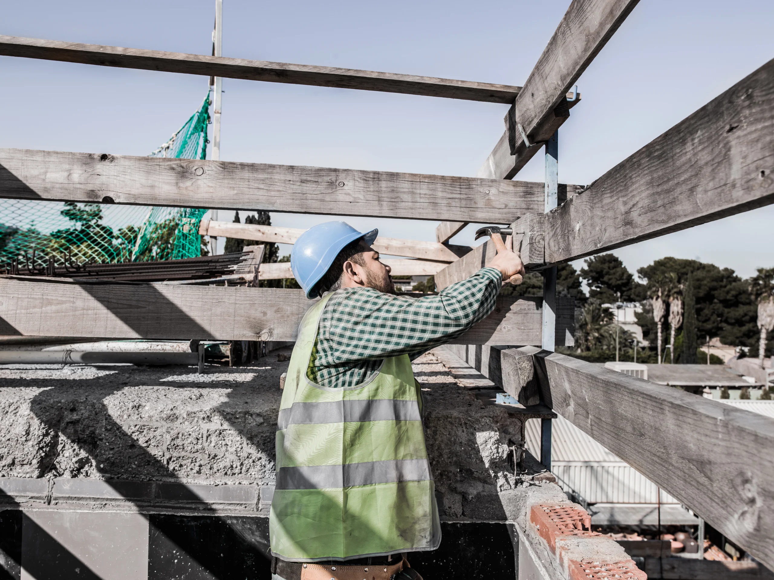 Construction executives reviewing project financial reports while analyzing labor costs, material prices, and project profitability.